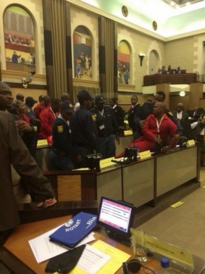 EFF MPs are removed by police from the Gauteng Provincial Legislature for wearing red overalls, 1 July 2014. Picture: @EconFreedomZA via Twitter